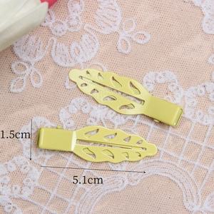 Set of two 5.1cm leaf-shaped hair clips in bright yellow finish with duckbill design