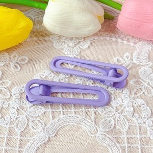 Matte purple hollow duckbill hair clips set on a floral lace background with tulips