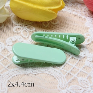 Vue détaillée de deux barrettes vert menthe avec dents antidérapantes, taille 2x4,4cm