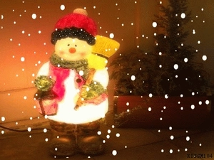 Close-up of glowing resin snowman figurine with red hat and broom for Christmas decor