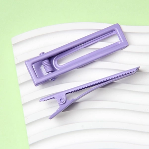 Détails macro de barrettes à cheveux violettes évidées sur présentoir ondulé