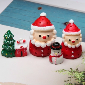 Micro shot of resin Christmas miniatures featuring Santa, snowman and snowy cottage