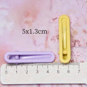 Minimalist U-shaped hair clips in candy colors showing 5cm x 1.3cm size measurement