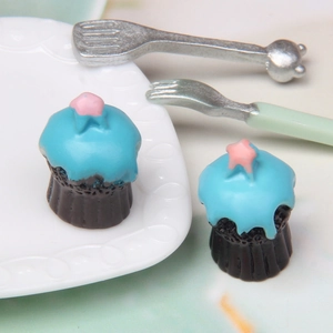 Set of two miniature chocolate cupcakes with blue frosting and pink star decor for dollhouses