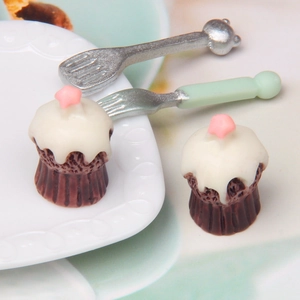 Macro shot of miniature simulation cupcakes with star topping and tiny cutlery set