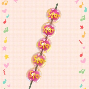 Close-up of clear acrylic star beads with pink core and yellow Star lettering details
