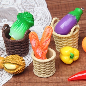 Detailed macro view of miniature resin vegetable charms in tiny woven baskets for dollhouses