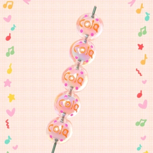 Detail of pink acrylic cola beads for DIY jewelry with soft pastel pattern design