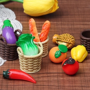 Detailed close-up of colorful resin miniature fruits and vegetables in a tiny woven basket
