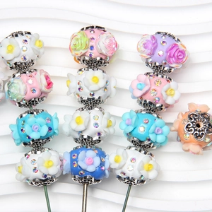 Macro detail of 3D floral beads with crystals and hollow metal bases for DIY jewelry