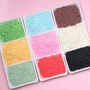 Macro detail of multi-colored polymer clay crumbs and sprinkles in white trays for DIY crafts