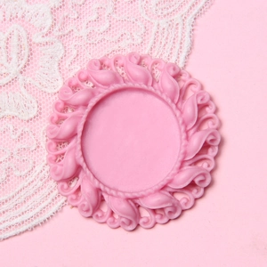 Pink round vintage relief base for DIY jewelry making with elegant swirl pattern edges