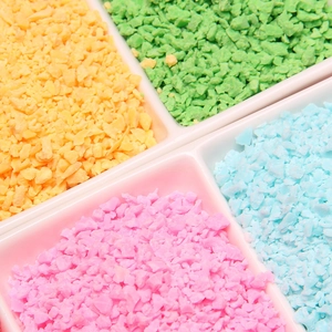 Colorful irregular clay sprinkles in a 4-compartment storage box for DIY crafts