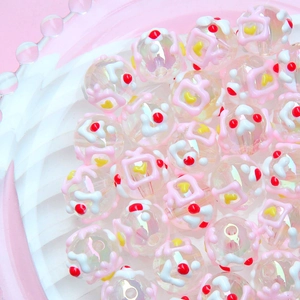 Macro shot of colorful hand-painted DIY acrylic beads with cute TV patterns in a clear tray