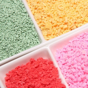 Detailed close-up of colorful decorative polymer clay sprinkles in four vibrant colors