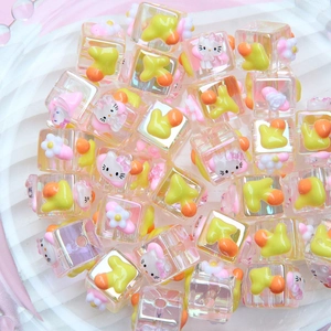 Macro shot of Hello Kitty and duckling acrylic beads for DIY jewelry and phone charms