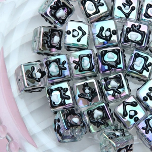 Macro view of iridescent cube glass beads with abstract patterns for DIY jewelry