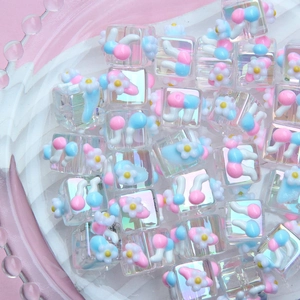 Macro shot of 3D floral resin beads with aurora finish for DIY jewelry crafts