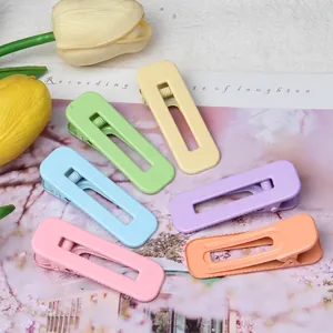 Macaron color square open hair clips set on floral background with yellow tulips