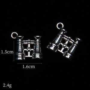 Detail view of retro silver telescope alloy pendants for DIY jewelry making