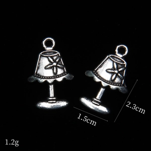 Detailed macro view of retro silver desk lamp alloy charms with dimensions 2.3x1.5cm