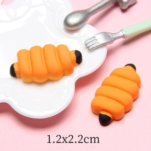 Detailed macro view of an orange resin caterpillar miniature measuring 1.2x2.2cm
