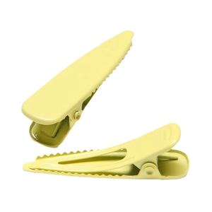 Pale yellow matte metal duckbill hair clips with serrated edges for secure grip on white background