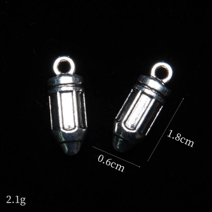 Macro shot of silver bullet alloy charms with 1.8cm length and 0.6cm diameter specs