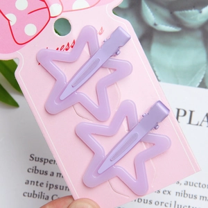 Set of two purple star hair clips on a pink Princess card for girls' dopamine styling