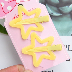 Set of two yellow hollow star hair clips with matte finish on decorative card display