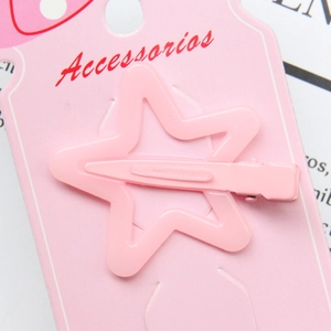 Detailed view of a pink star-shaped hair clip secured on a branded accessory display card