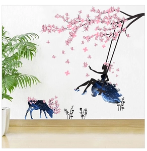Detail of dreamlike starry elk and flower fairy wall decals on a white home wall