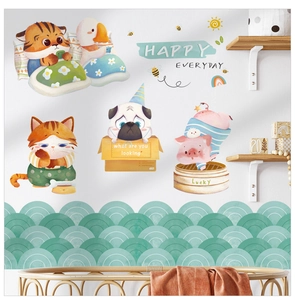 Detail of waterproof cartoon wall stickers featuring cute pets on a kitchen tile backsplash