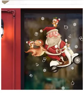 Detail view of Santa on a vintage scooter and dinosaur Christmas window stickers