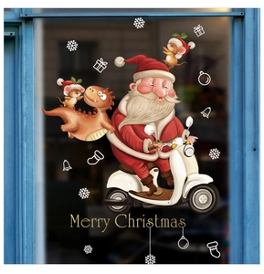 Detail of Christmas window sticker with Santa on scooter, dinosaur and gold Merry Christmas text