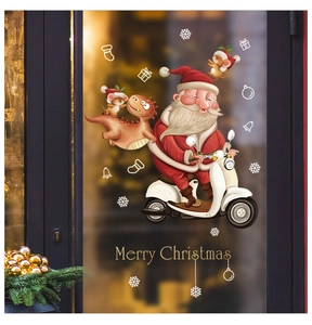Close-up of festive Christmas window stickers showing Santa on a scooter with cute dinosaurs