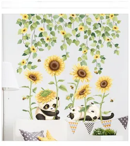 Detail showing hand-drawn sunflower vine stickers with a cute panda and cat on a sofa wall