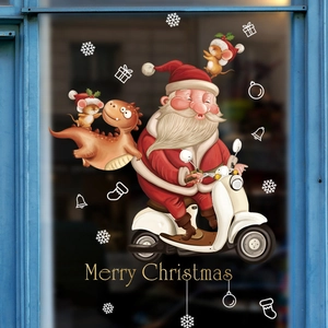 Christmas window stickers with Santa on scooter, dinosaur and snowflakes on blue glass background