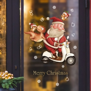 Christmas window decals with Santa on scooter, dinosaur and snowflakes on glass door