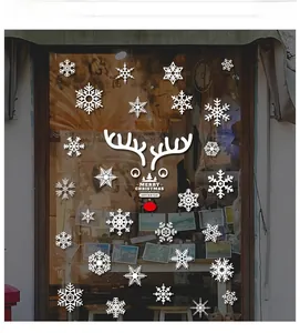 Detail showing white snowflake and Merry Christmas reindeer decals on glass window