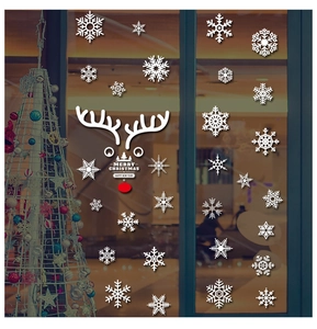 Christmas window decals showing white snowflakes and reindeer on glass for 2025 holiday decor