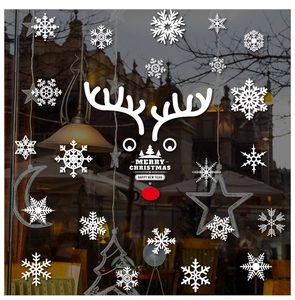 Close-up of snowflake and reindeer window stickers on a glass pane for Christmas decor