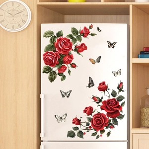 Detail of self-adhesive red rose and butterfly wall stickers on a white refrigerator surface