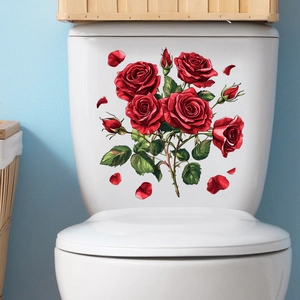 Detail view of red rose floral adhesive decals applied to a white ceramic toilet tank