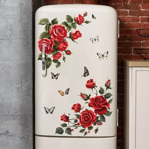 Detail of red rose and butterfly wall stickers on a vintage white refrigerator
