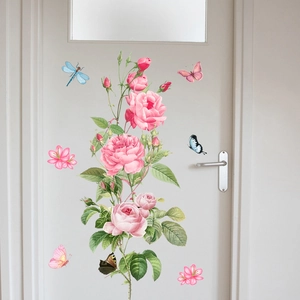 Detail view of pink rose and butterfly wall stickers applied on a white interior door