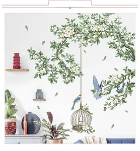 Détail d'autocollants muraux feuilles tropicales avec oiseaux bleus et cage vintage