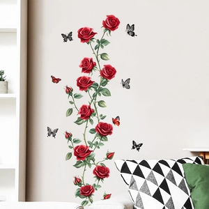 Detail of red rose vine and butterfly wall stickers applied on light living room walls
