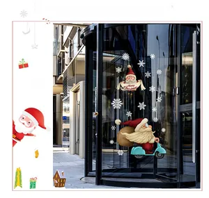 Detail of Santa Claus static stickers on glass door with snowflakes for Christmas decor