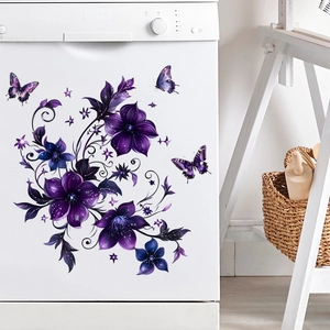 Detail of purple flower and butterfly wall stickers applied on white appliance surface